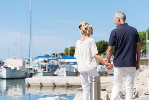 Elderly couple holding hands